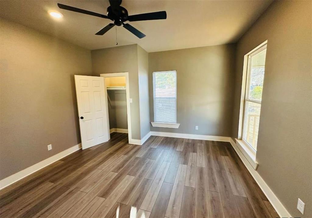 1408 East Houston Street Tyler, TX 75702 - Photo 10 of 15 an empty room with wooden floor and windows