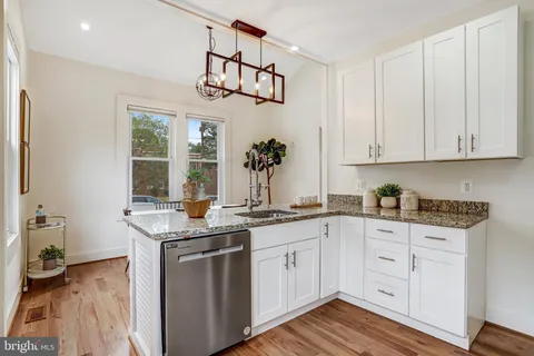 a kitchen with stainless steel appliances granite countertop a sink and cabinets