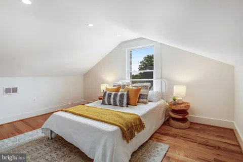 a bedroom with a bed and a mirror