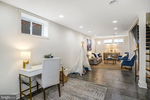 a living room with furniture and a glass door