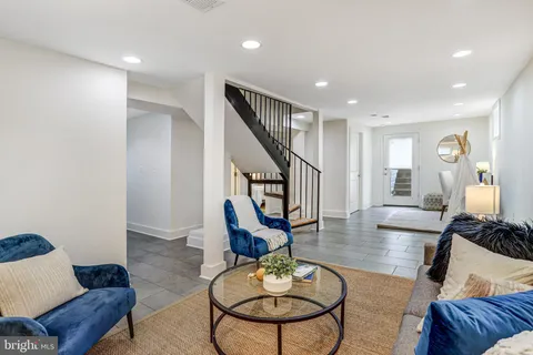a living room with furniture and a dining table