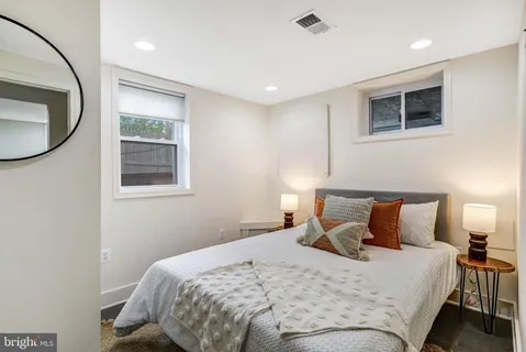 a bedroom with a bed and a mirror