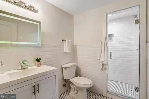 a bathroom with a sink toilet and a mirror