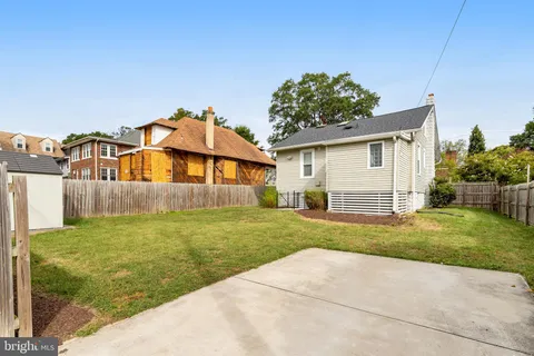 a view of backyard of house and car parked