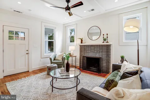 a living room with furniture a rug and a fireplace