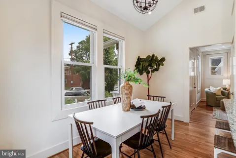 a view of a dining room with furniture window and wooden floor