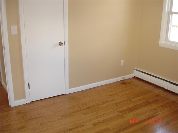 297 West Allen Ridge Road Springfield, MA 01118 - Photo 8 of 18 an empty room with wooden floor and windows