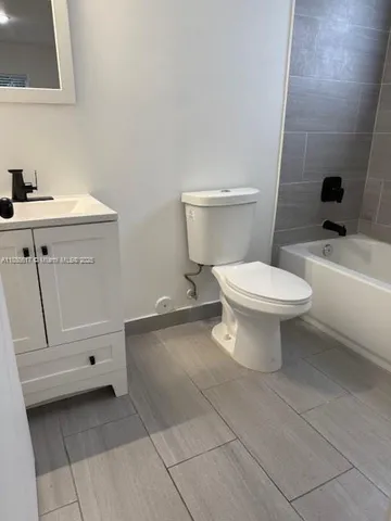 a bathroom with a toilet sink and vanity