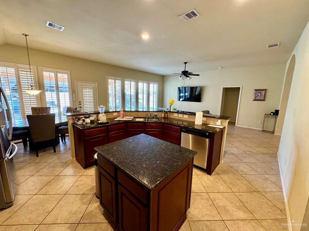 2911 San Rafael Street Mission, TX 78572 - Photo 38 of 38 a kitchen with a stove a sink a counter top space and living room view