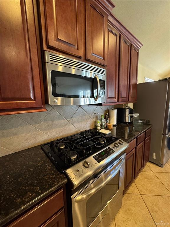 2911 San Rafael Street Mission, TX 78572 - Photo 13 of 38 a kitchen with granite countertop a stove and a microwave
