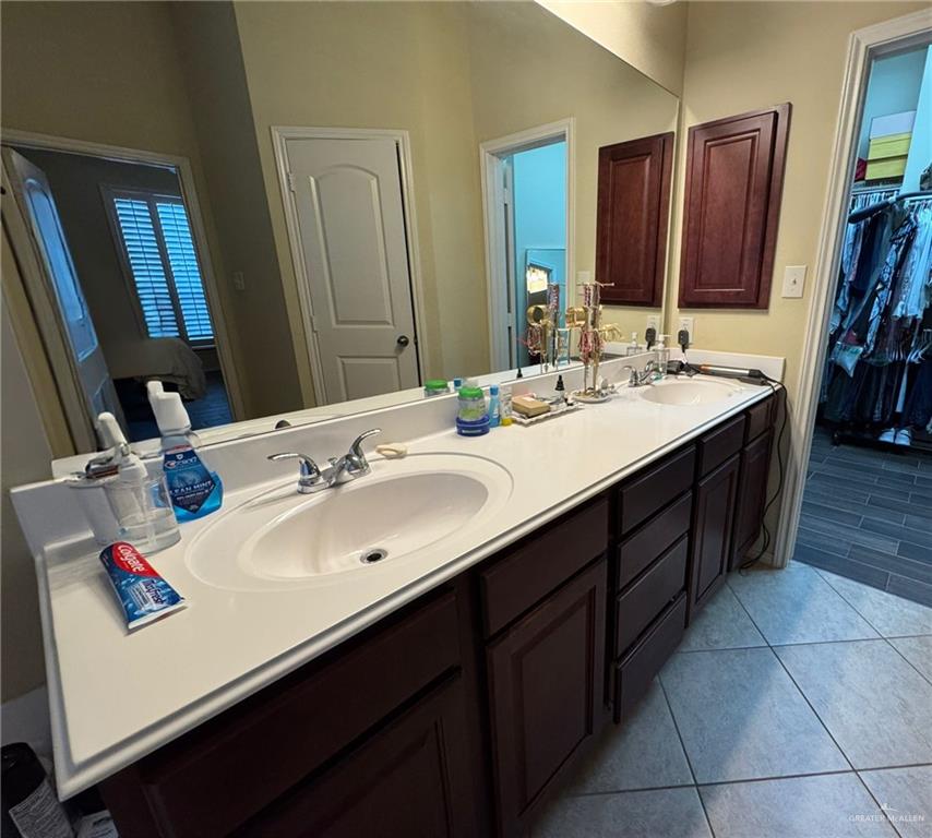 2911 San Rafael Street Mission, TX 78572 - Photo 21 of 38 a bathroom with a sink double vanity granite and a mirror