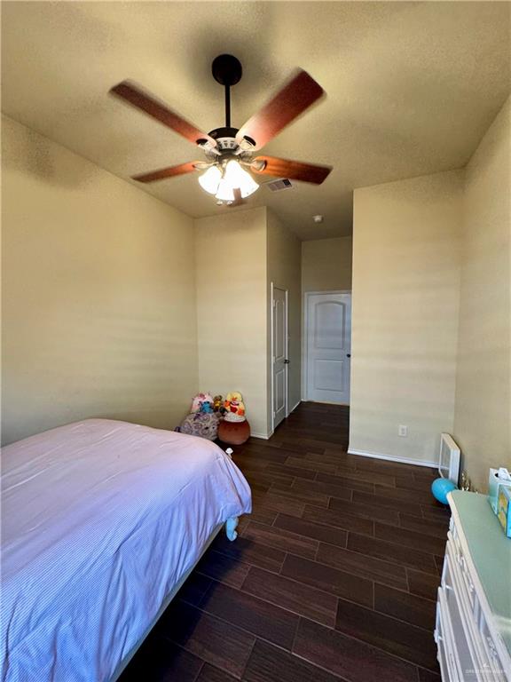 2911 San Rafael Street Mission, TX 78572 - Photo 24 of 38 a bedroom with a large bed and a ceiling fan