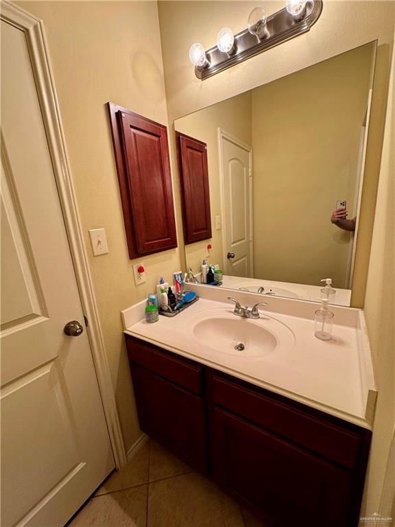 2911 San Rafael Street Mission, TX 78572 - Photo 28 of 38 a bathroom with a sink a mirror and shower