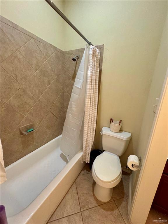 2911 San Rafael Street Mission, TX 78572 - Photo 30 of 38 a white toilet sitting next to a bath tub and a shower