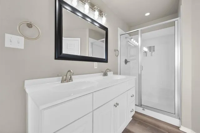 a bathroom with a double vanity sink mirror and