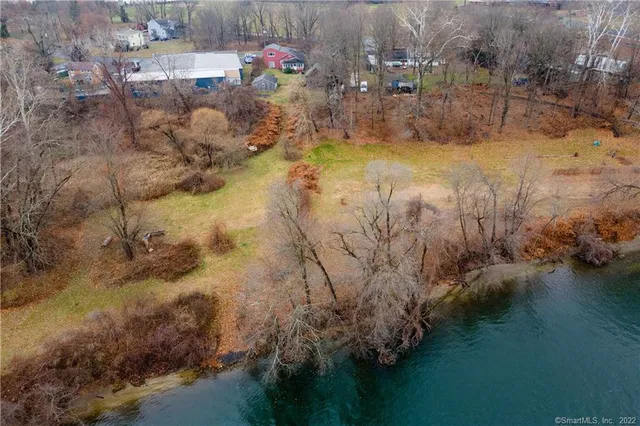 a kitchen with refrigerator a microwave a sink and cabinets