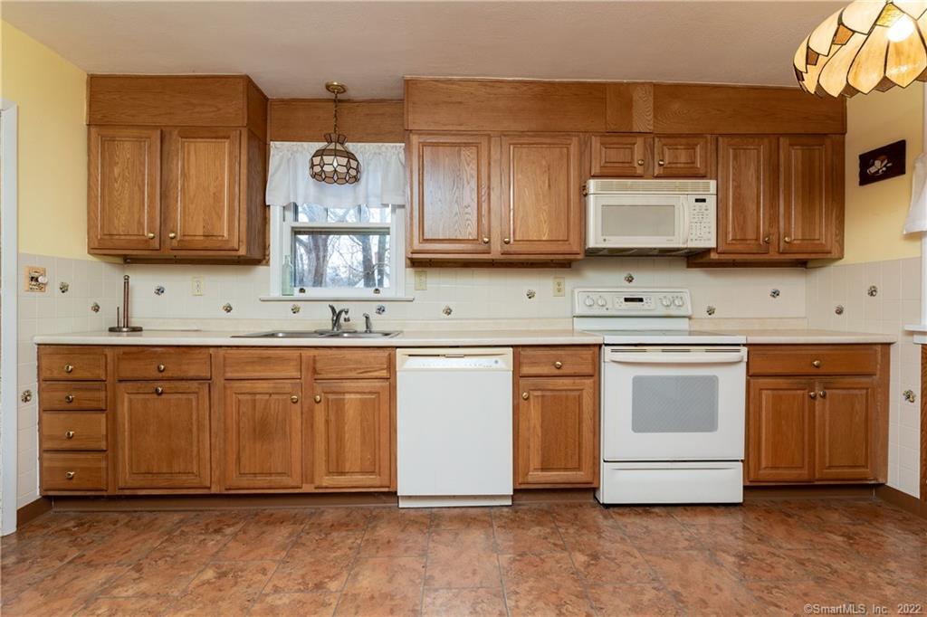 25 Pickett District Road New Milford, CT 06776 - Photo 13 of 34 a kitchen with stainless steel appliances granite countertop a sink a stove and cabinets