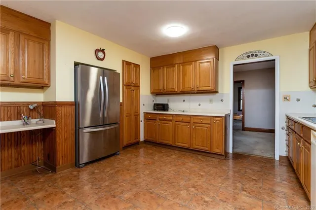 a kitchen with refrigerator and cabinets
