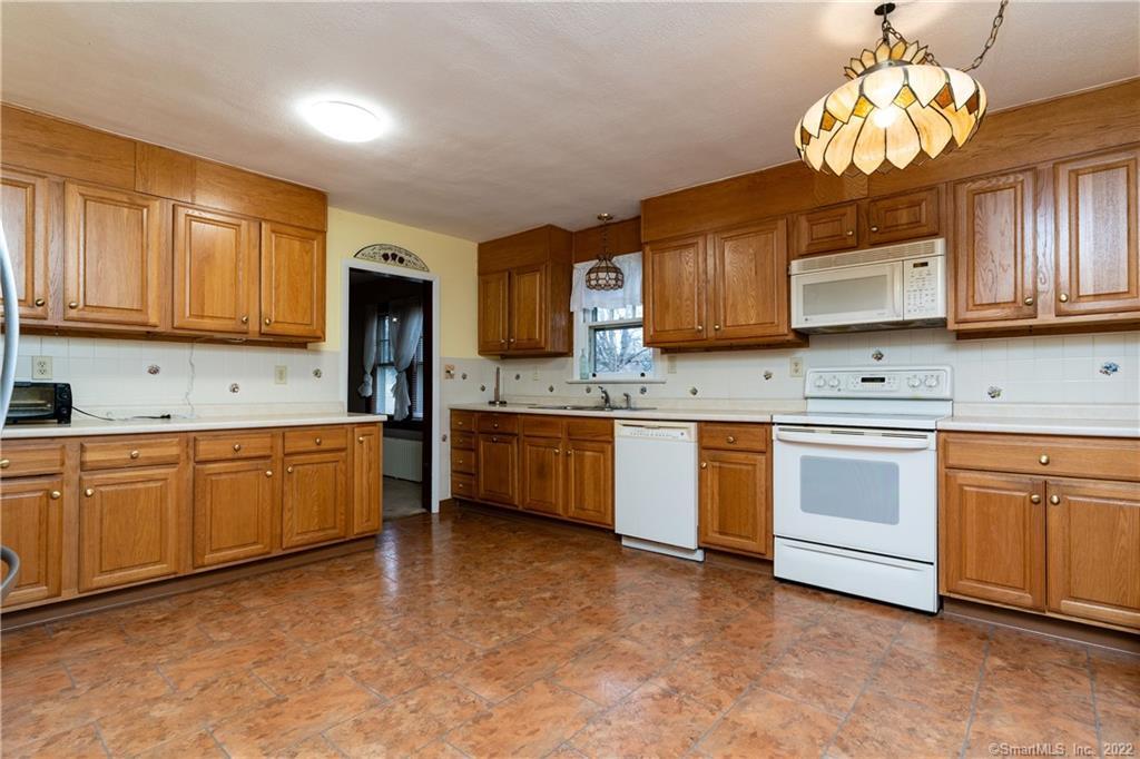 25 Pickett District Road New Milford, CT 06776 - Photo 15 of 34 a kitchen with a stove a sink dishwasher a microwave oven and a refrigerator