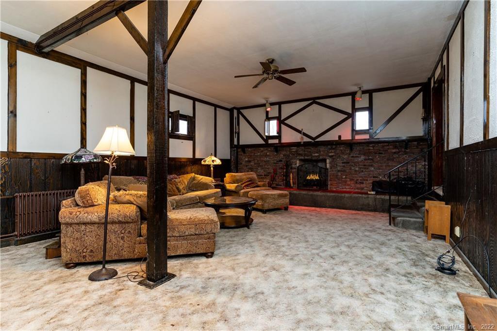 25 Pickett District Road New Milford, CT 06776 - Photo 21 of 34 a living room with furniture a fireplace and a flat screen tv
