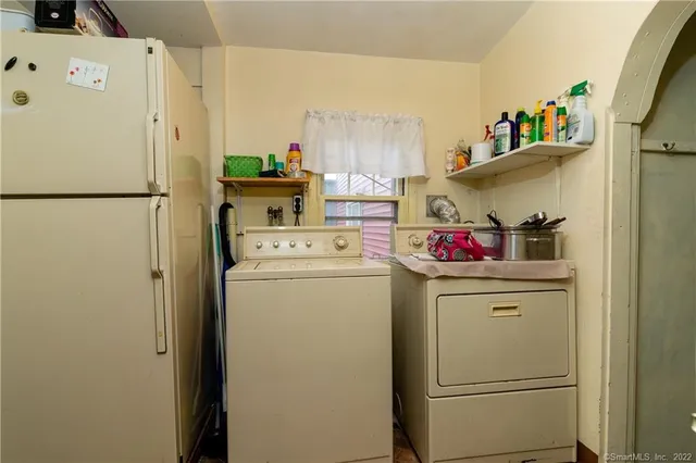 a living room with patio furniture and a potted plant