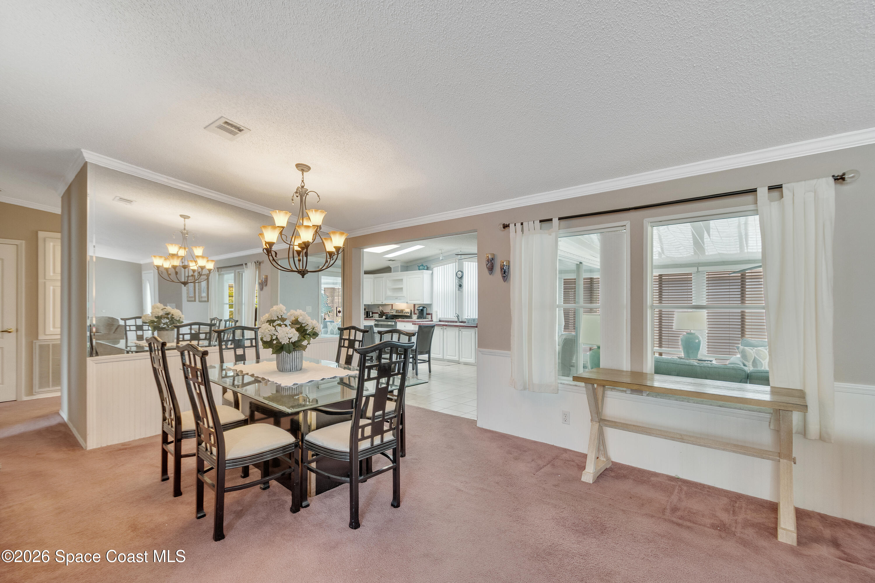 7669 Chasta Road Micco, FL 32976 - Photo 11 of 34 a view of a dining room with furniture and chandelier