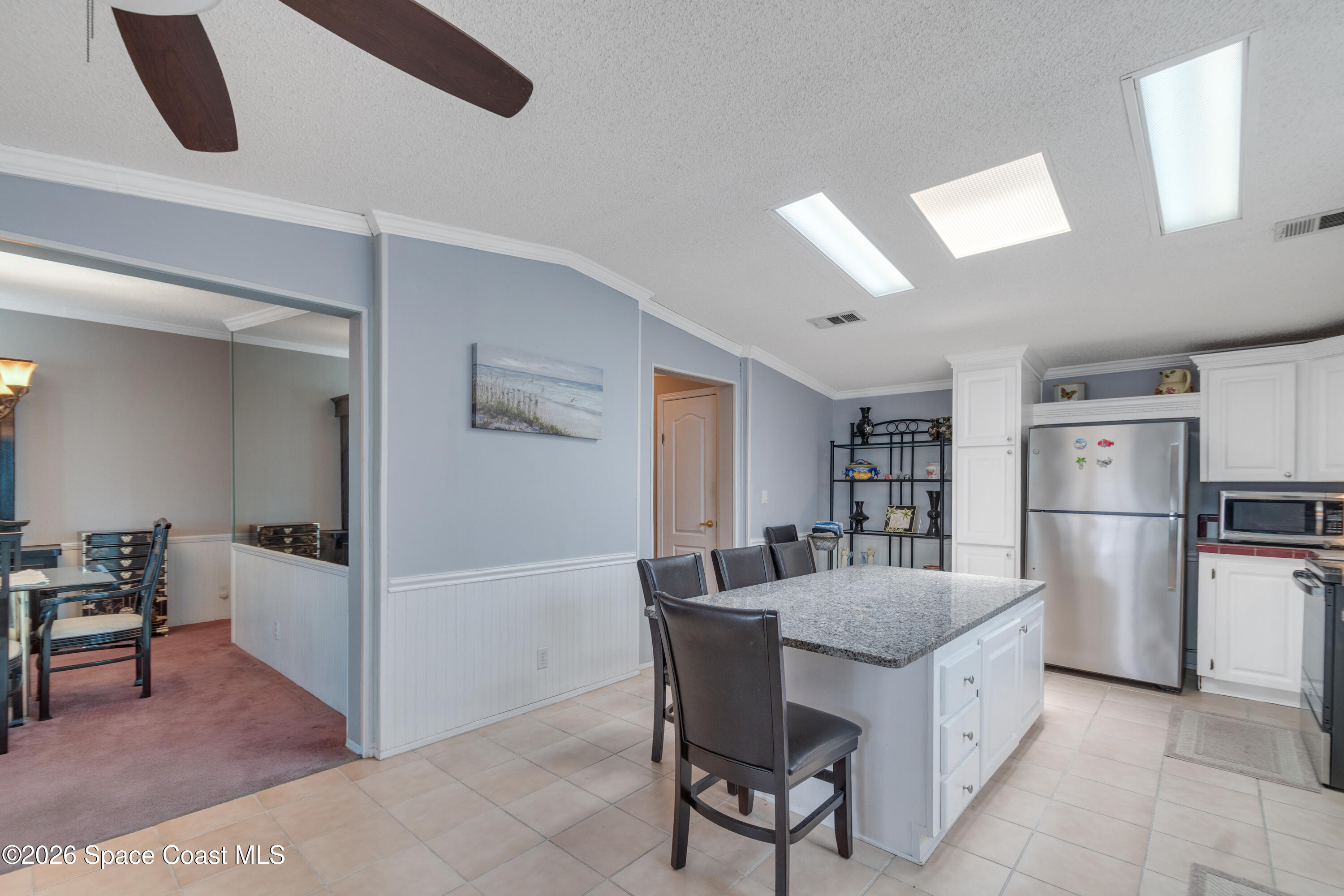 7669 Chasta Road Micco, FL 32976 - Photo 13 of 34 a dining room with furniture and kitchen view