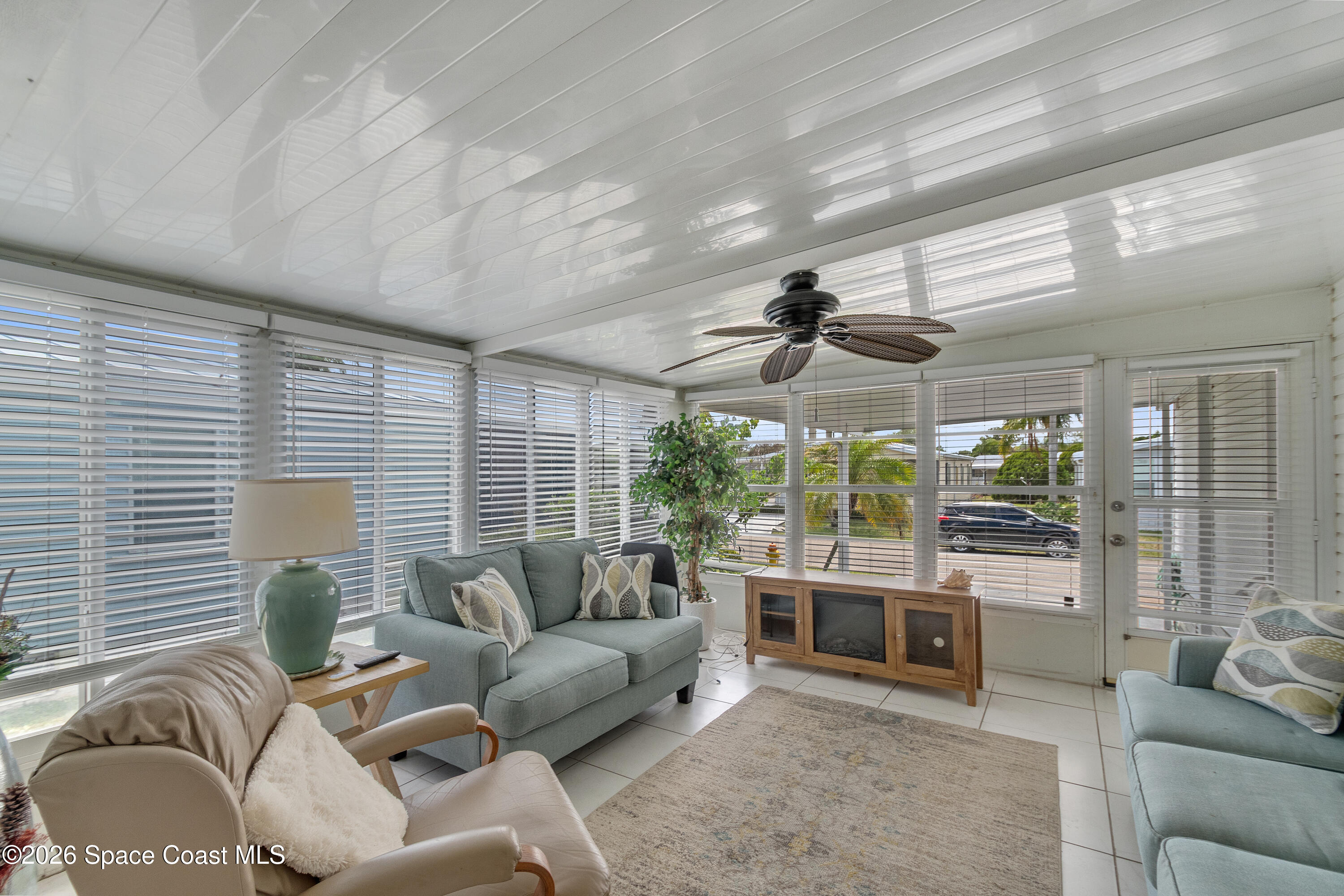 7669 Chasta Road Micco, FL 32976 - Photo 16 of 34 a living room with furniture and a large window