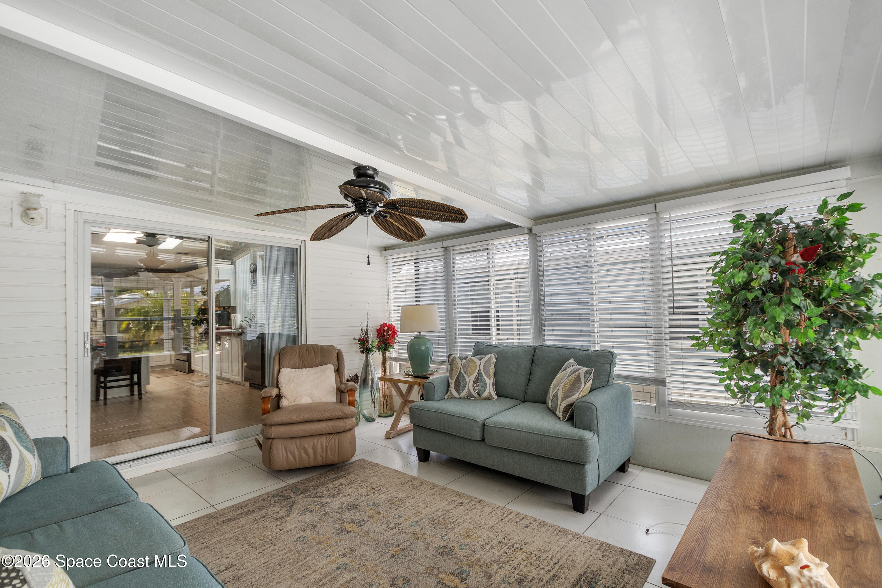 7669 Chasta Road Micco, FL 32976 - Photo 17 of 34 a living room with furniture and a large window