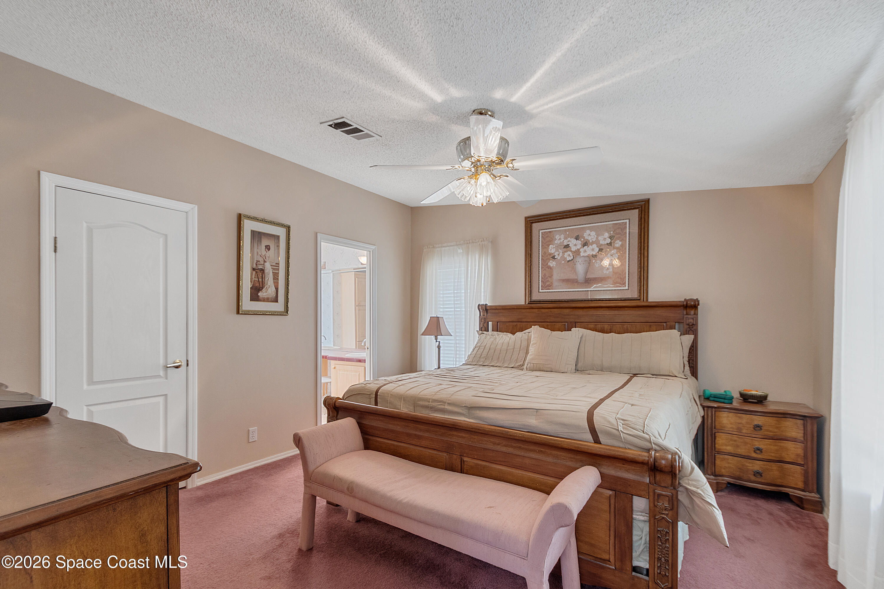 7669 Chasta Road Micco, FL 32976 - Photo 18 of 34 a bedroom with a bed and wooden floor