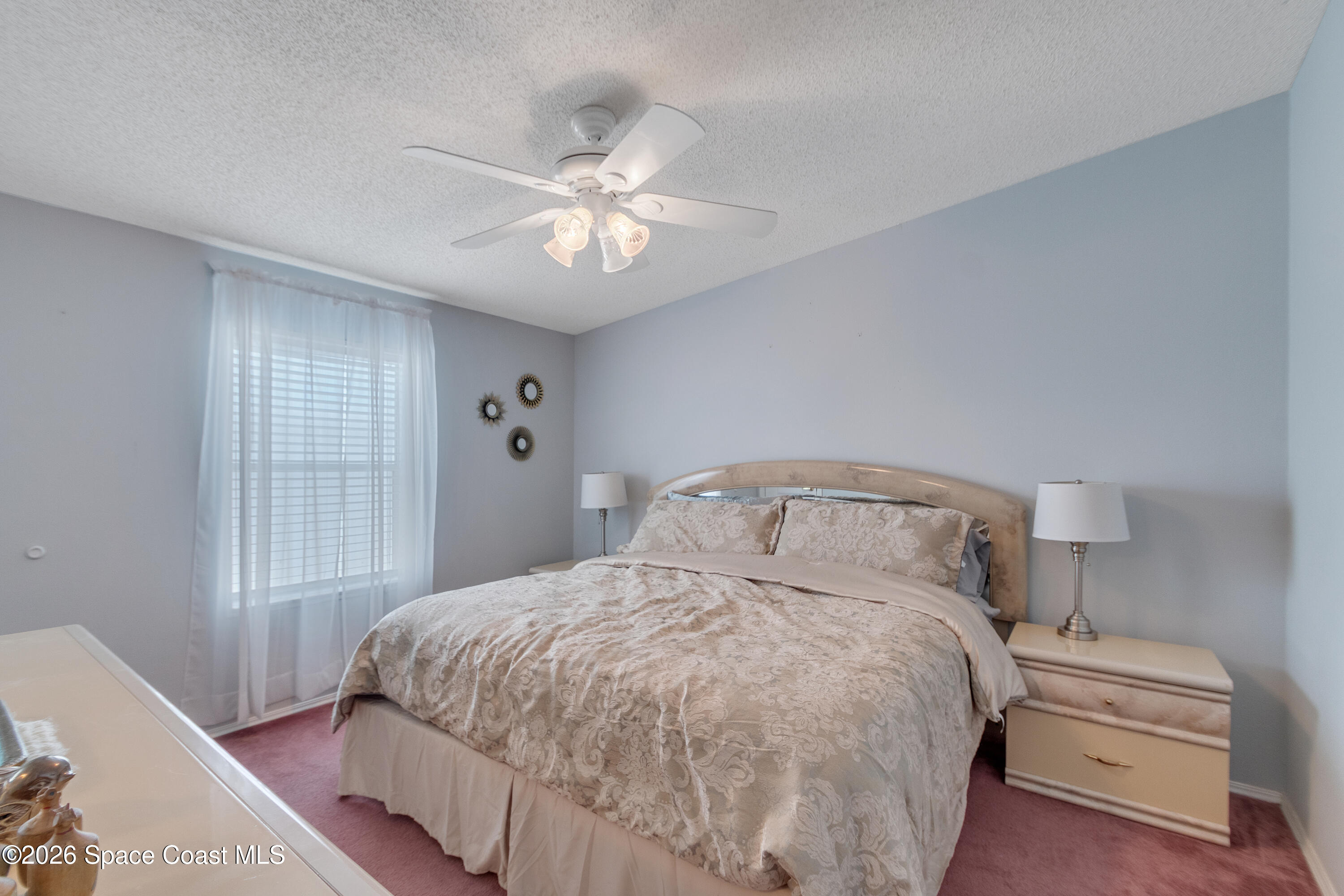 7669 Chasta Road Micco, FL 32976 - Photo 21 of 34 a bedroom with a bed and window