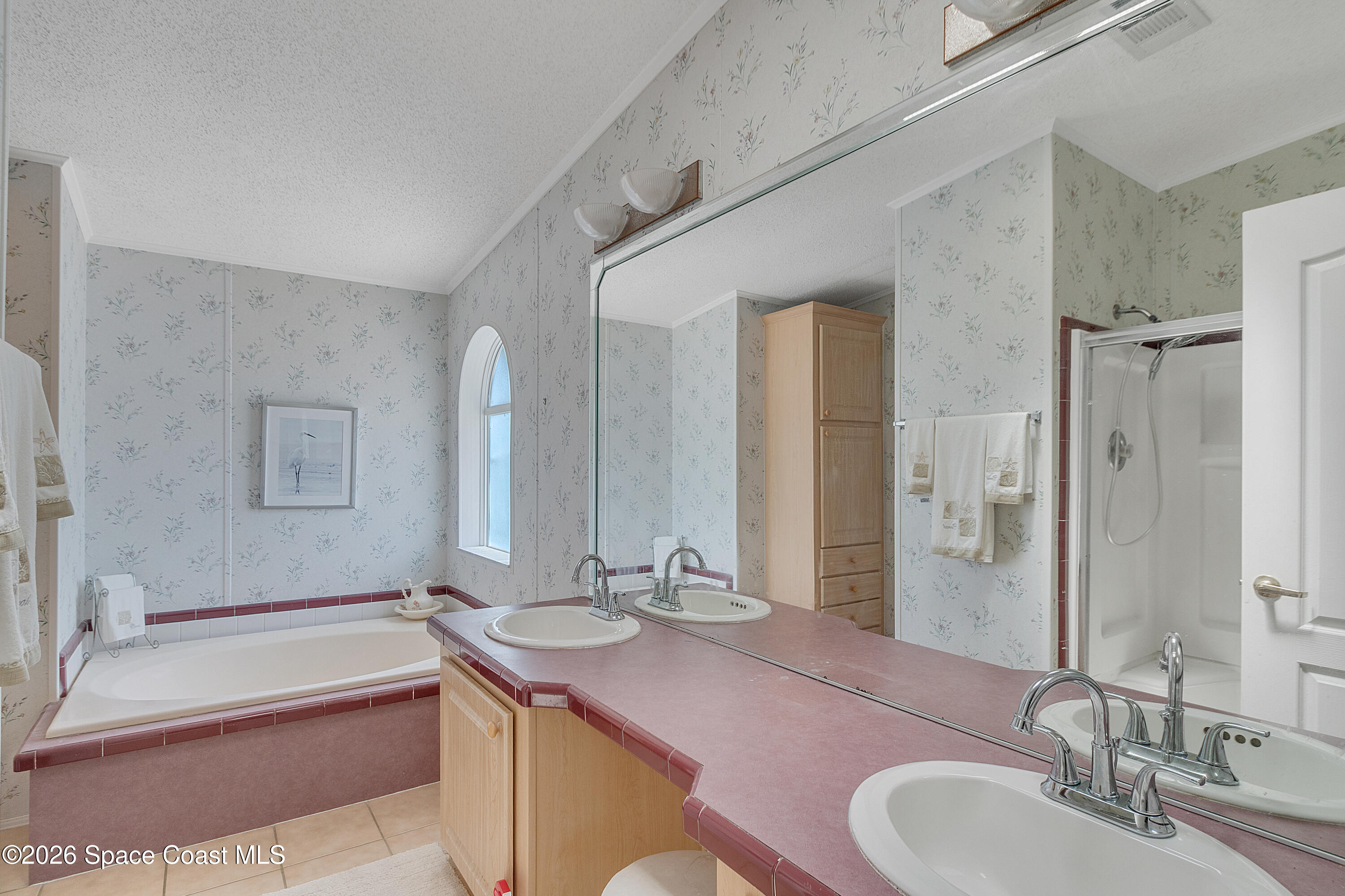 7669 Chasta Road Micco, FL 32976 - Photo 23 of 34 a bathroom with a granite countertop tub sink and mirror