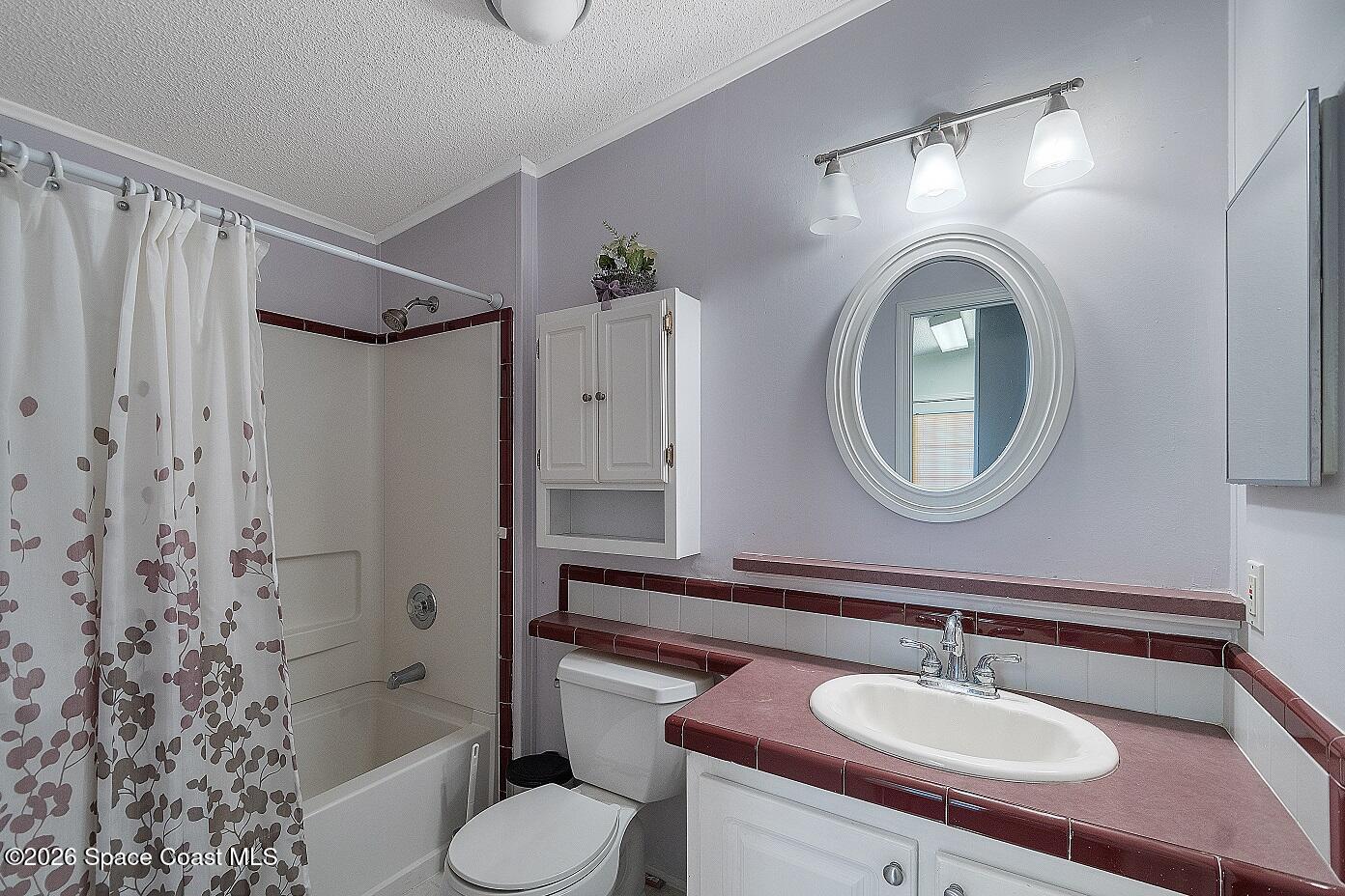 7669 Chasta Road Micco, FL 32976 - Photo 24 of 34 a bathroom with a sink toilet a mirror and shower