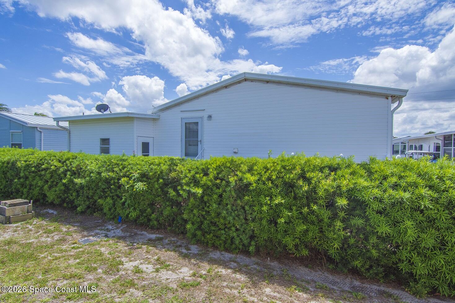 7669 Chasta Road Micco, FL 32976 - Photo 3 of 34 a backyard of a house with lots of green space