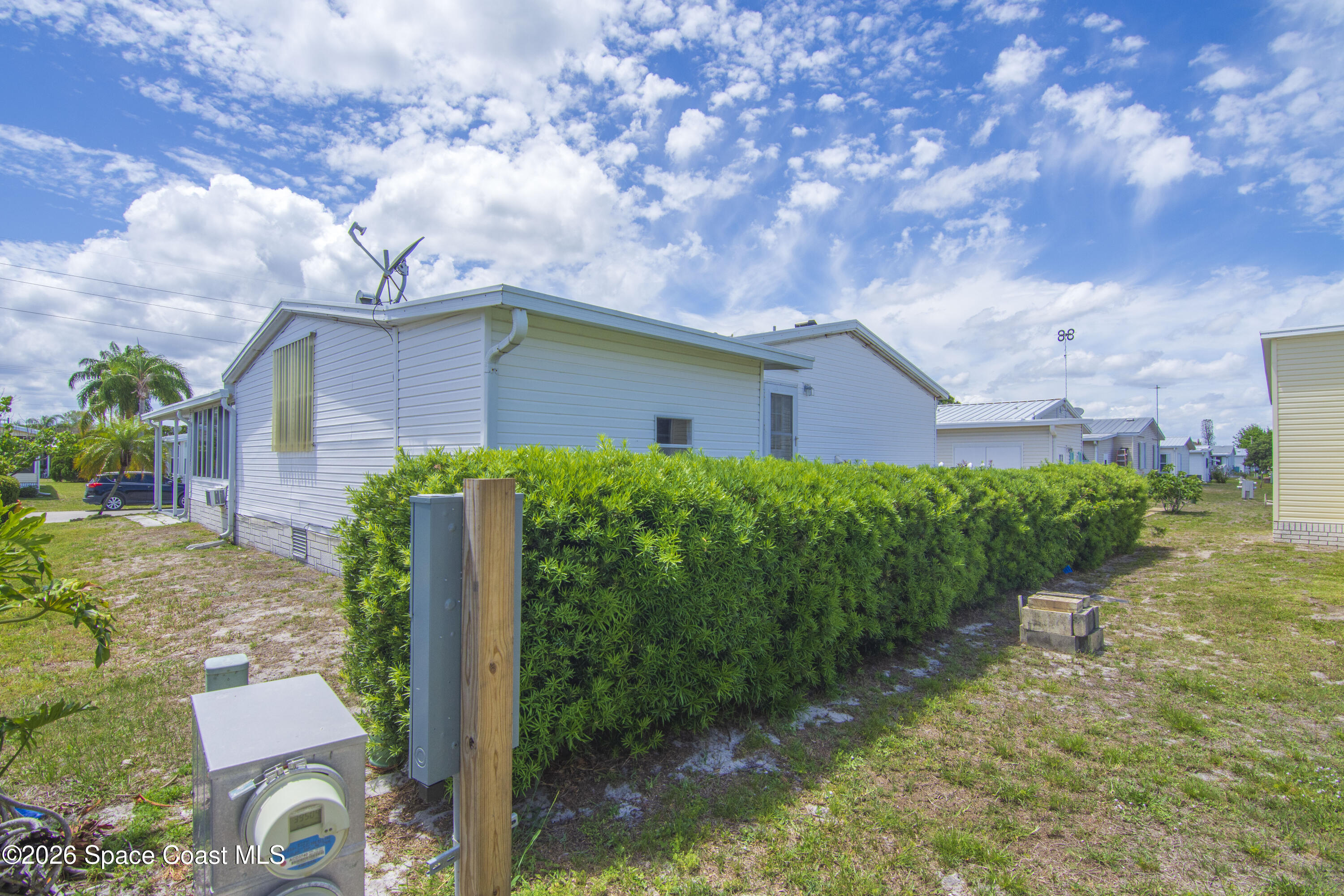 7669 Chasta Road Micco, FL 32976 - Photo 5 of 34 a front view of a house with garden