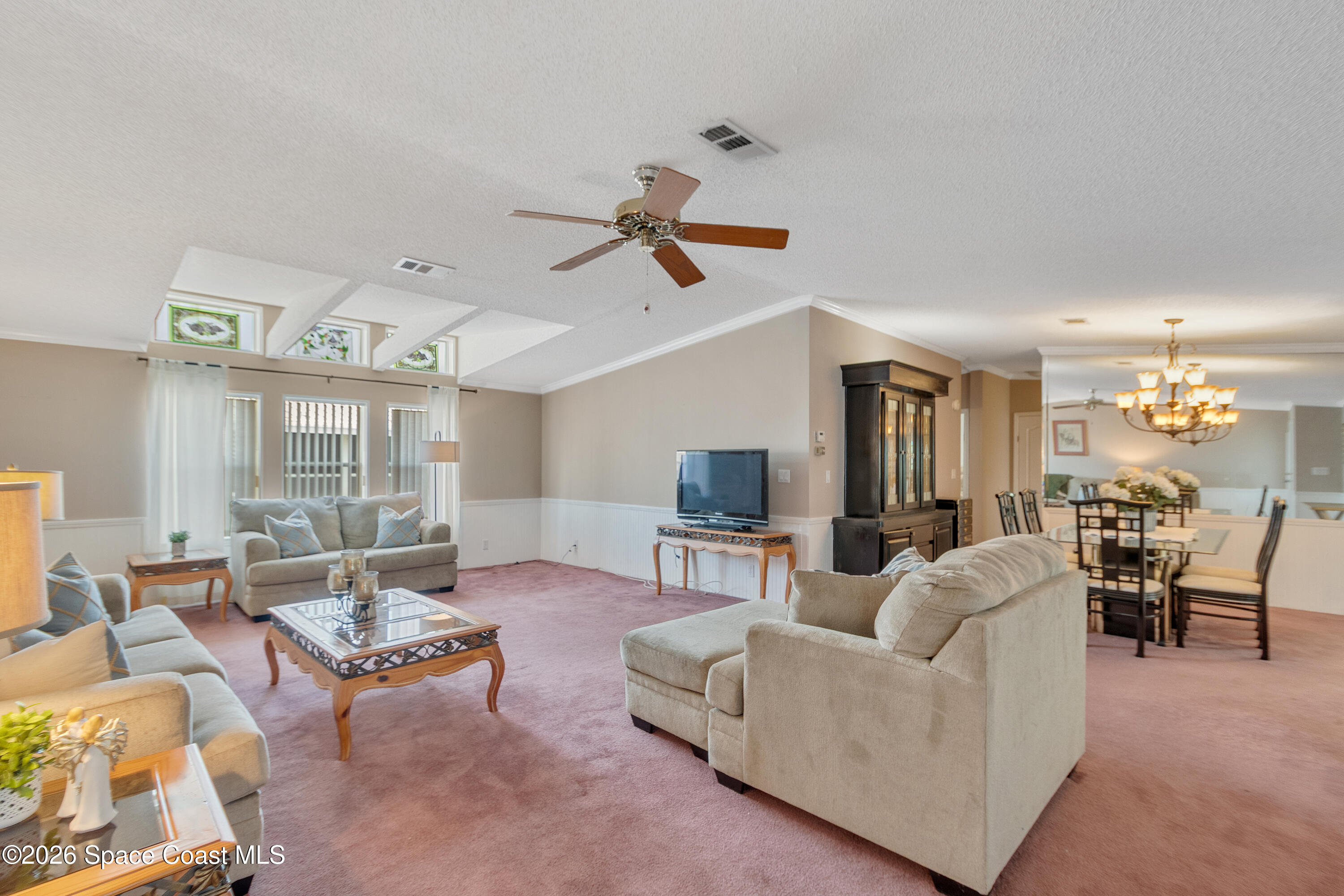 7669 Chasta Road Micco, FL 32976 - Photo 7 of 34 a living room with furniture ceiling fan and a rug