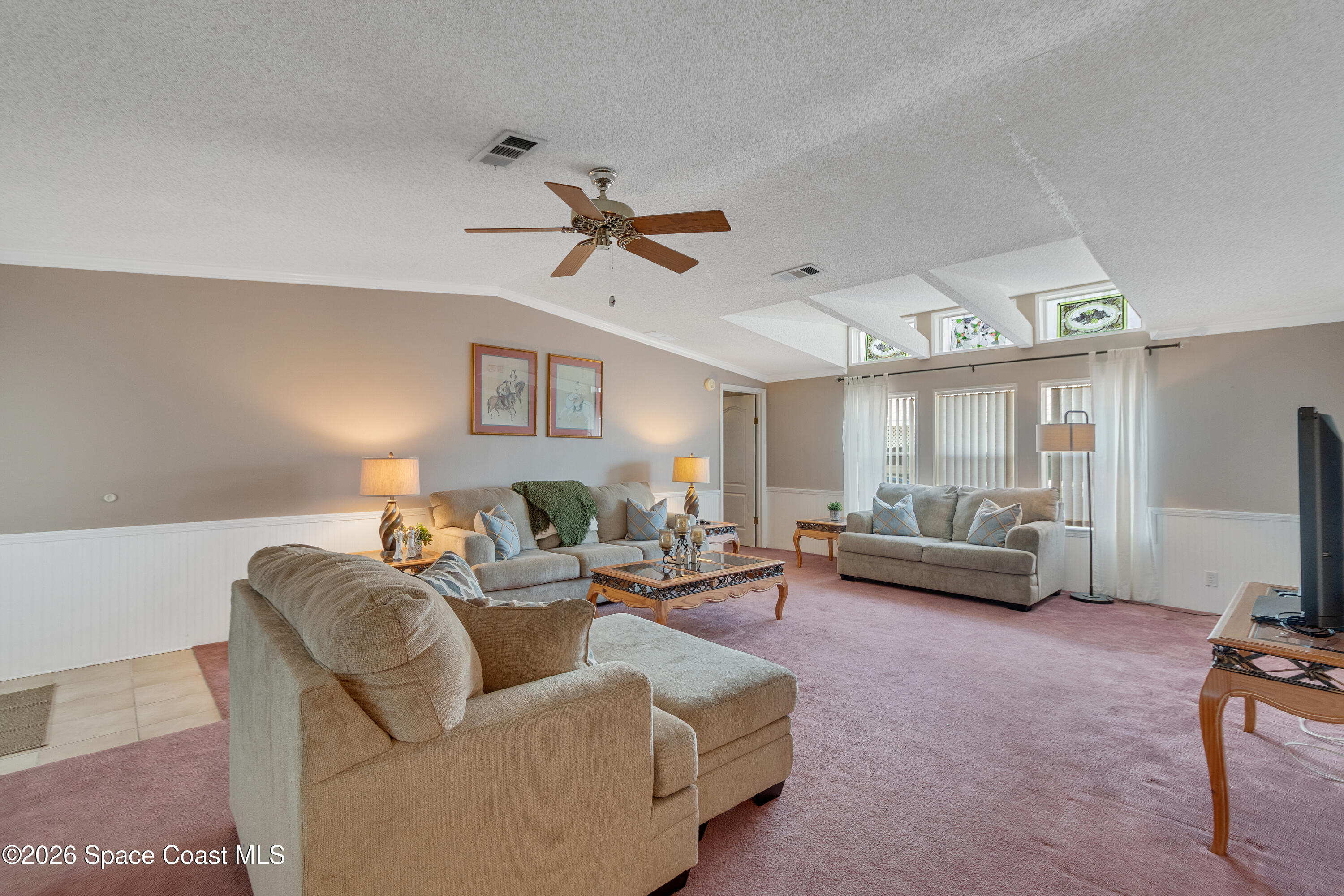 7669 Chasta Road Micco, FL 32976 - Photo 8 of 34 a living room with furniture ceiling fan and a window