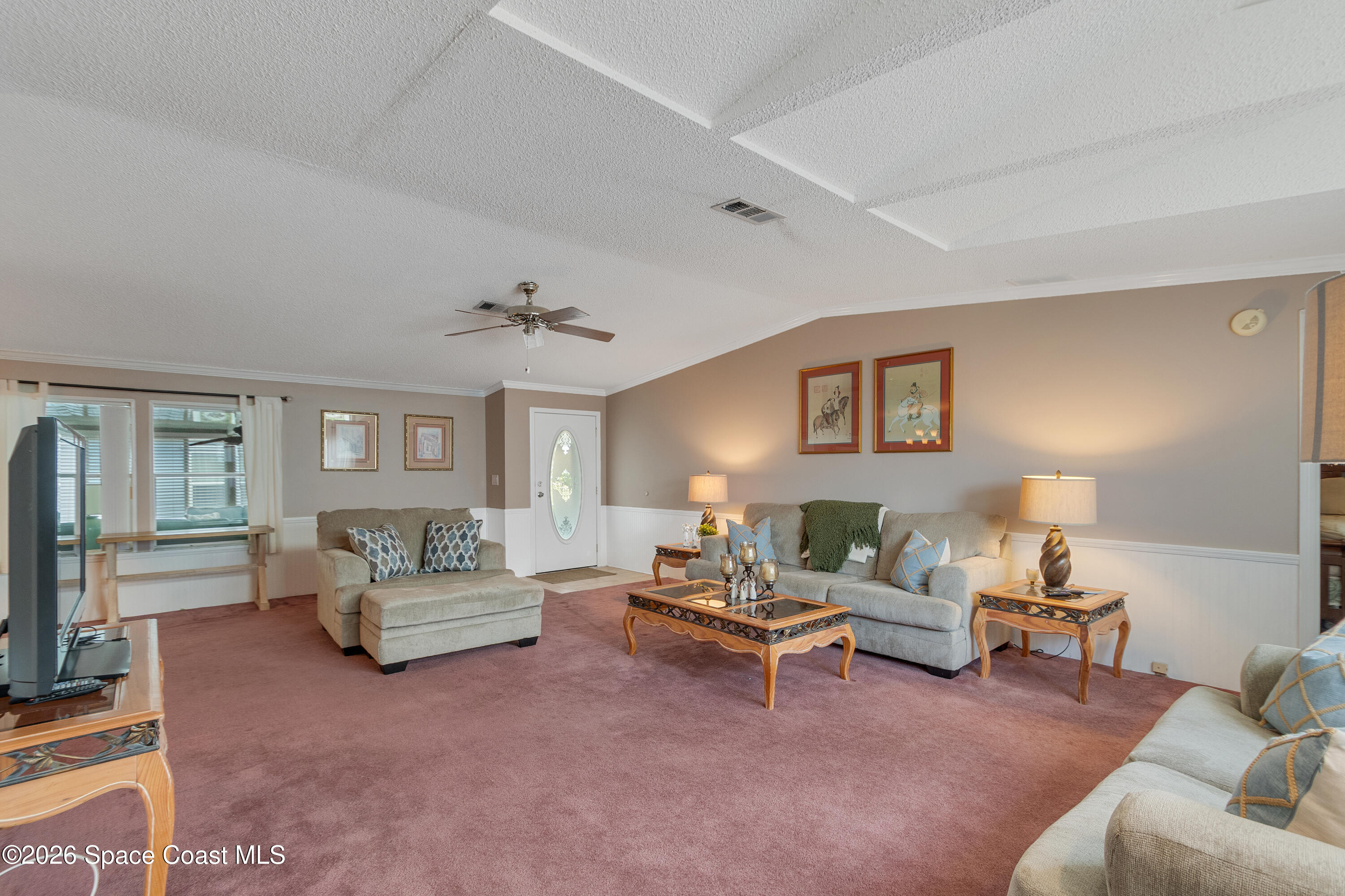 7669 Chasta Road Micco, FL 32976 - Photo 9 of 34 a living room with furniture and a large window