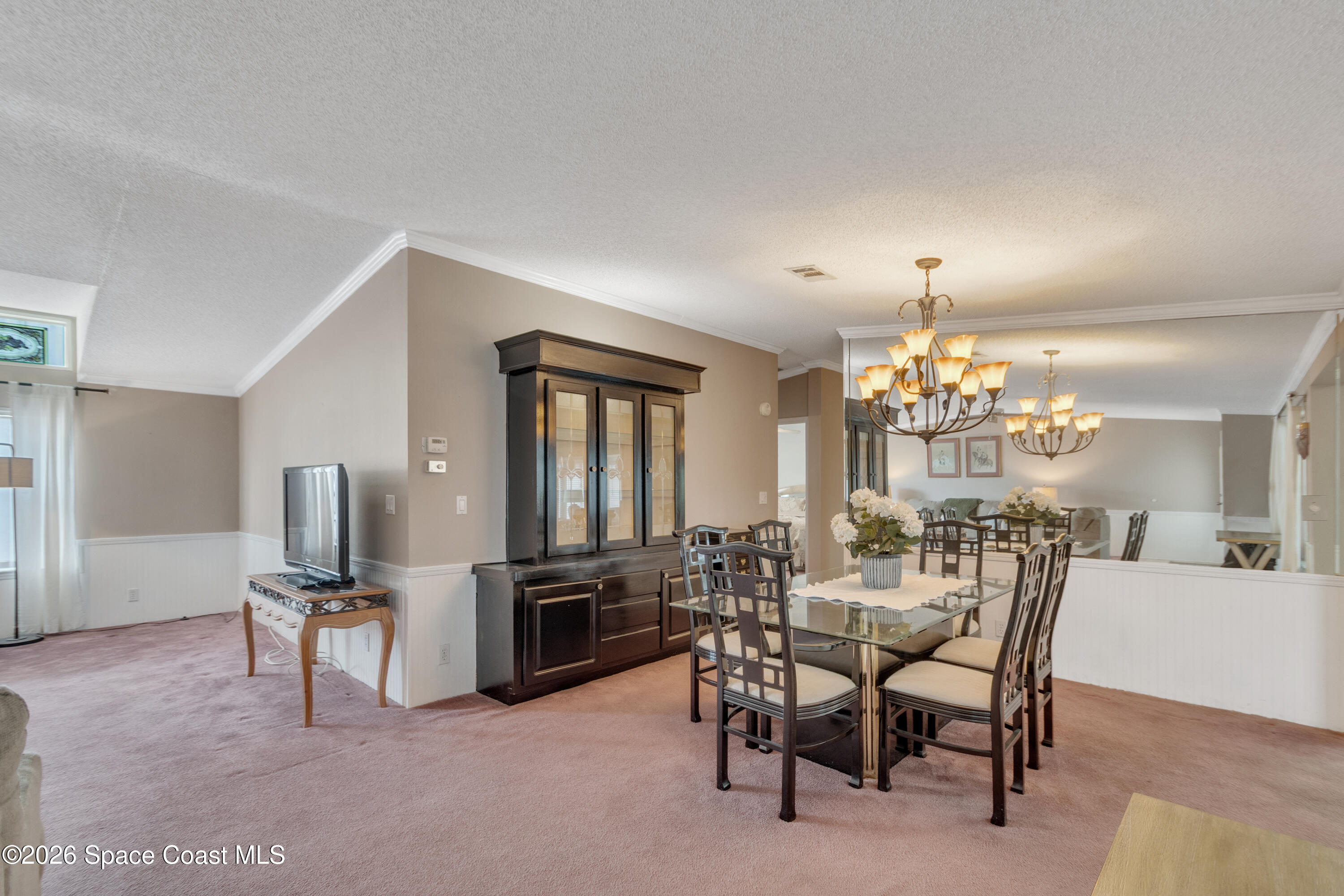 7669 Chasta Road Micco, FL 32976 - Photo 10 of 34 a view of a dining room with furniture and chandelier
