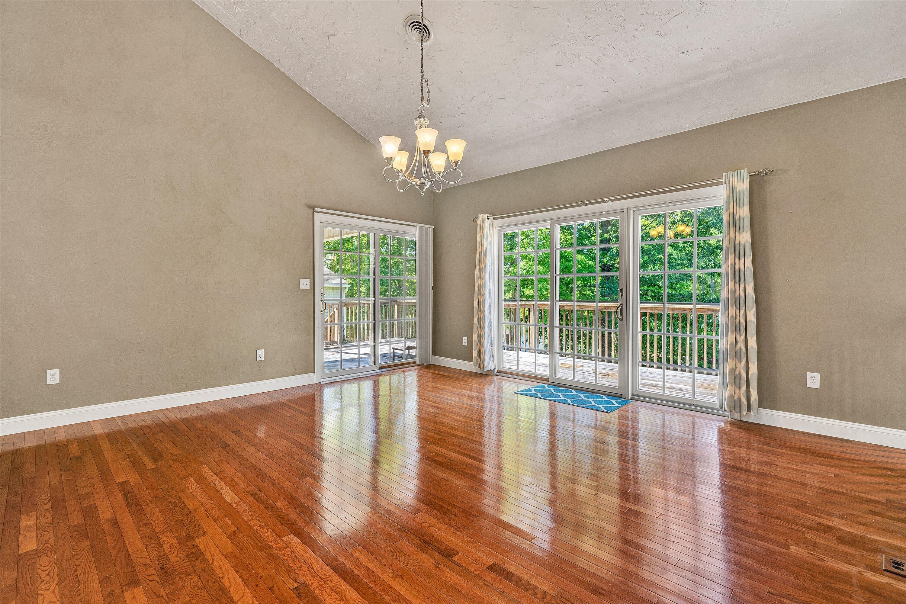 1805 Carroll Road Goodview, VA 24095 - Photo 16 of 61 a view of an empty room with wooden floor and a window