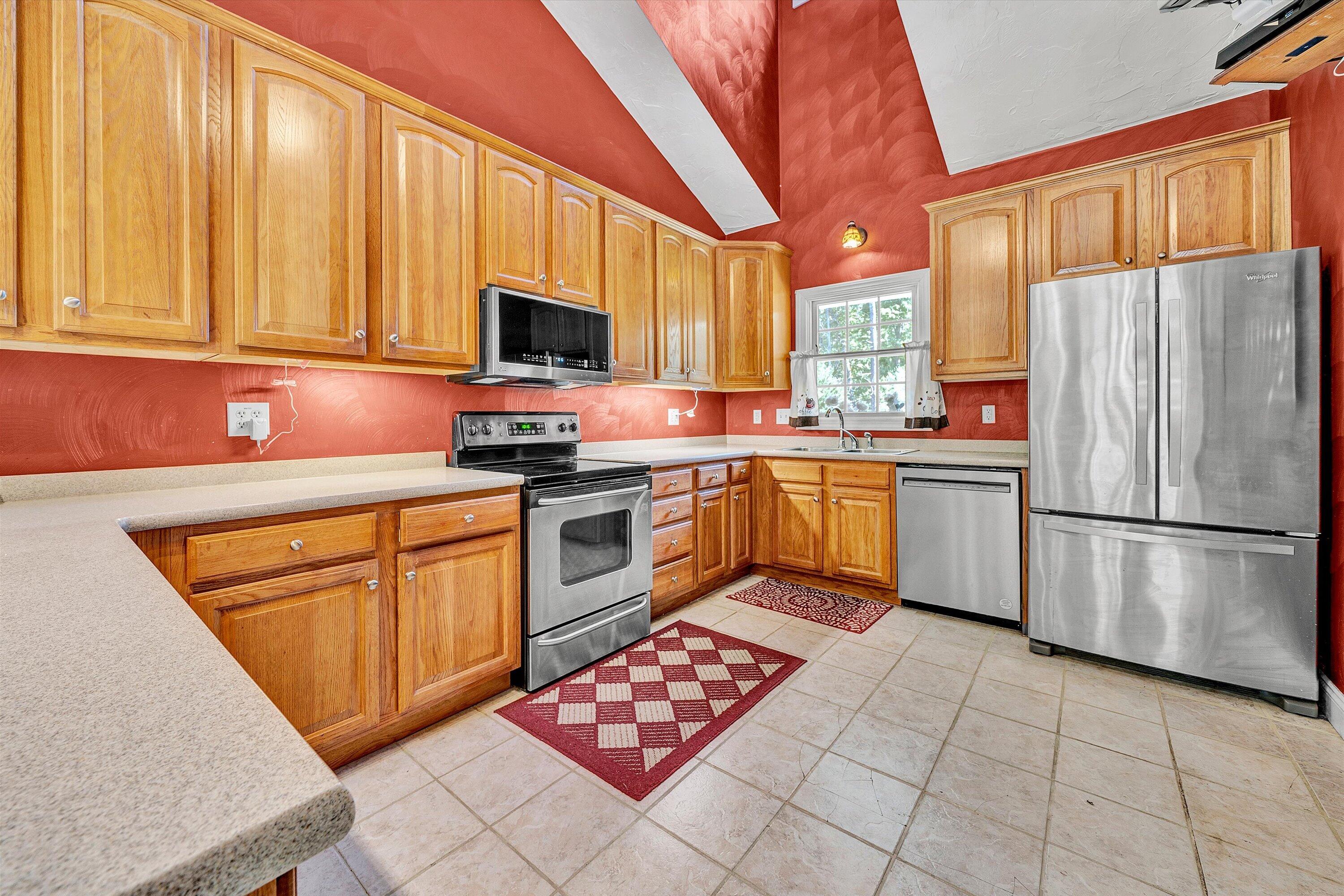 1805 Carroll Road Goodview, VA 24095 - Photo 20 of 61 a kitchen with stainless steel appliances granite countertop a refrigerator sink stove microwave and cabinets
