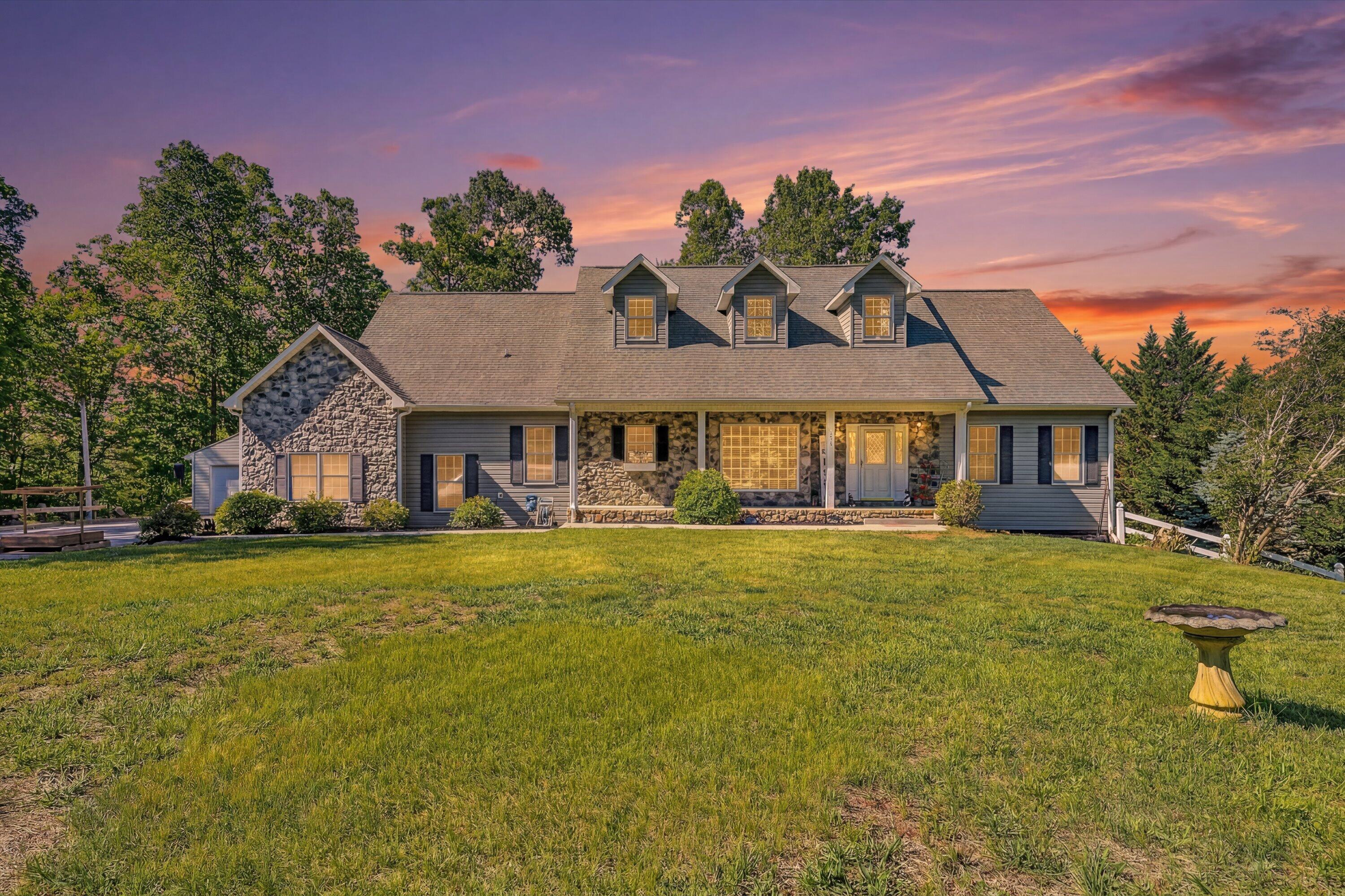 1805 Carroll Road Goodview, VA 24095 - Photo 2 of 61 a front view of a house with a garden