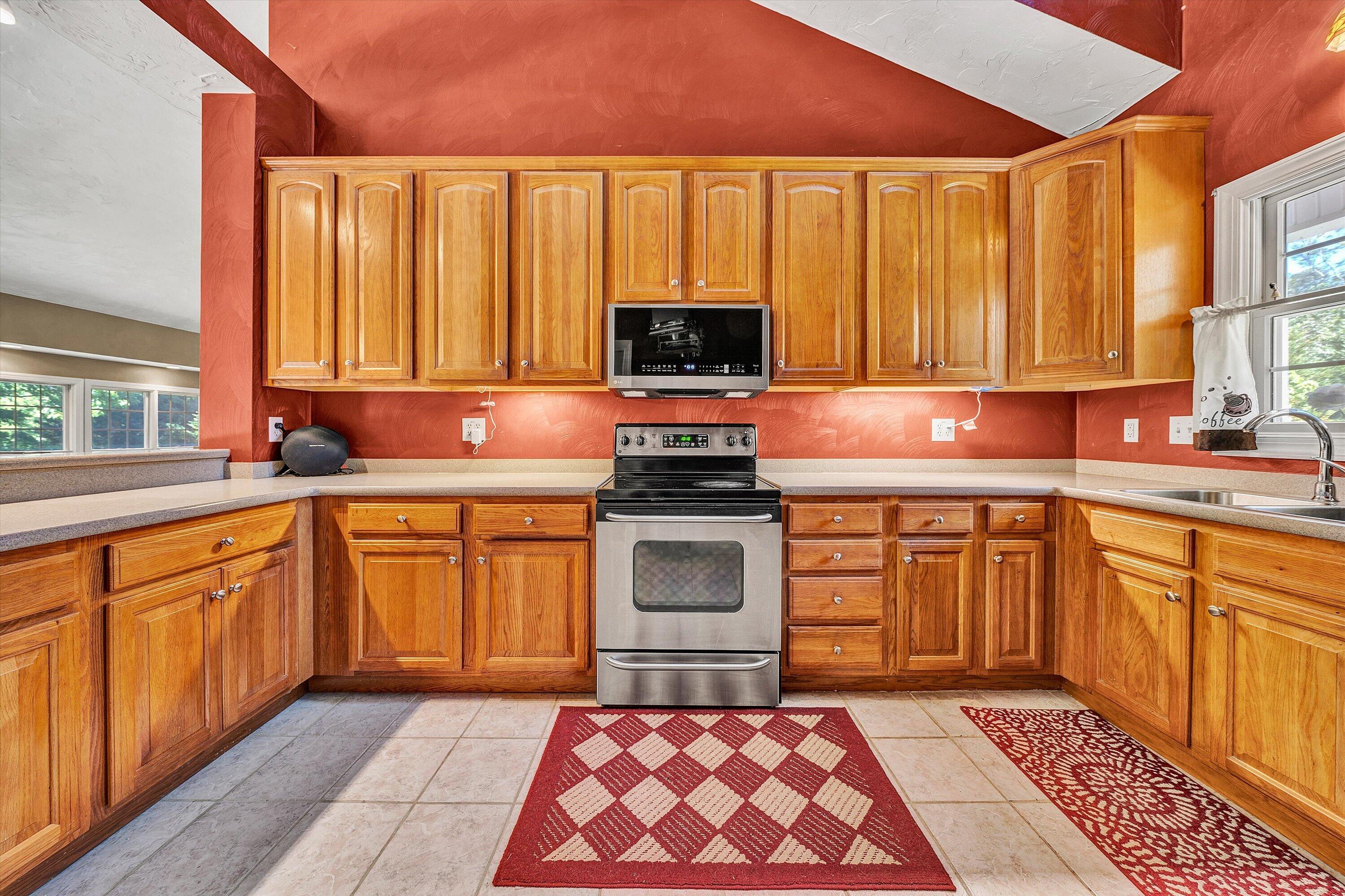 1805 Carroll Road Goodview, VA 24095 - Photo 22 of 61 a kitchen with a stove a sink and a microwave
