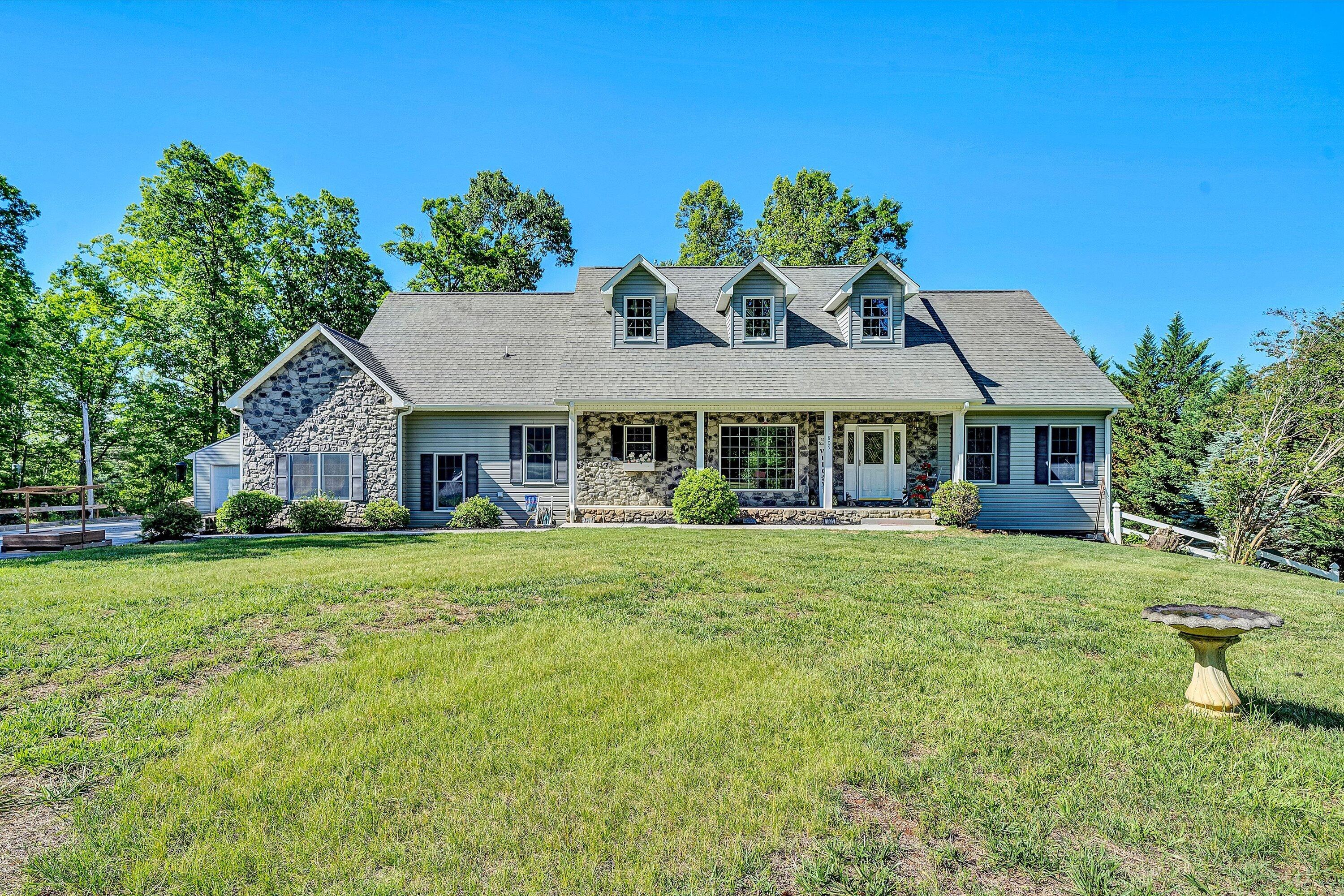 1805 Carroll Road Goodview, VA 24095 - Photo 56 of 61 a front view of a house with a garden and porch