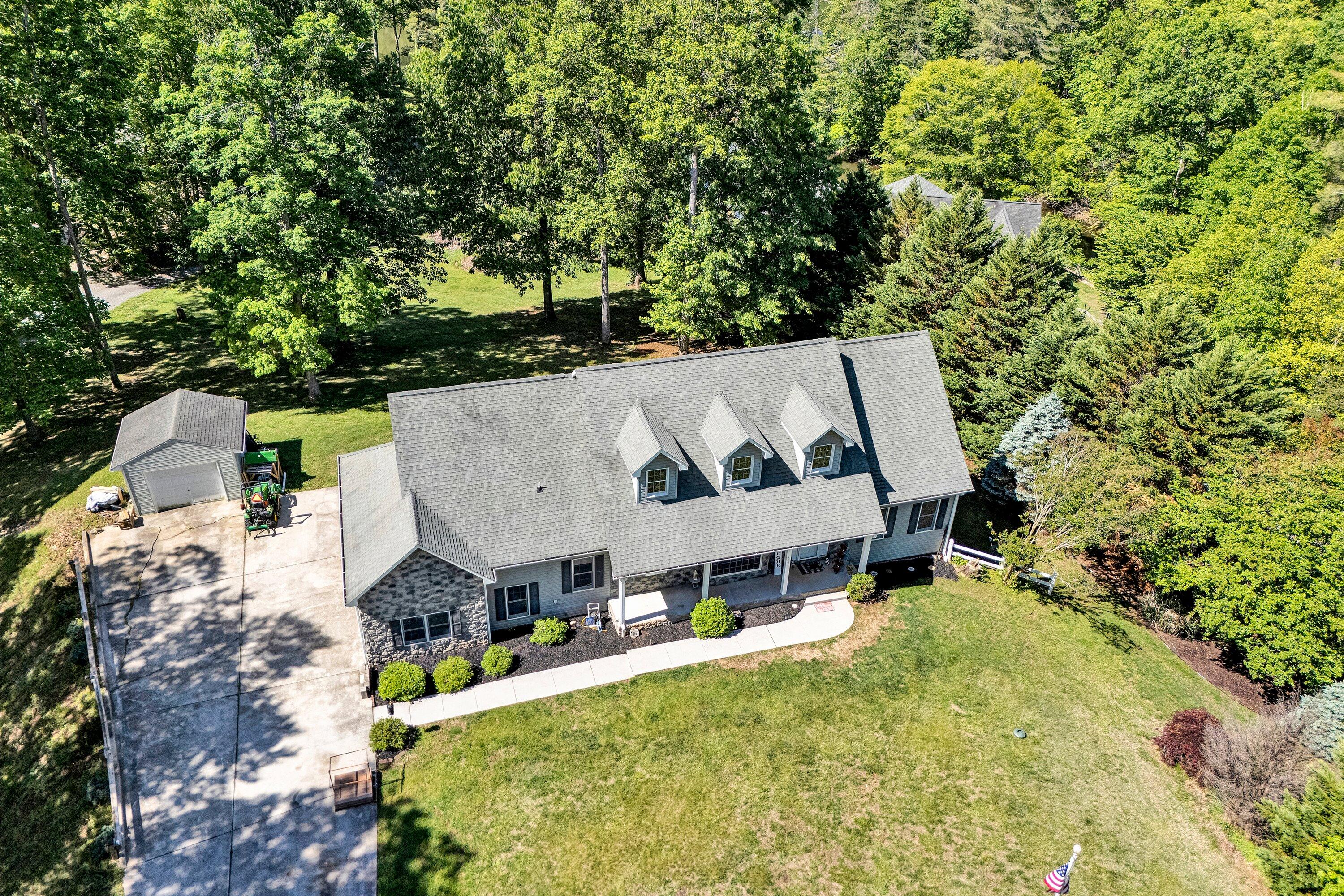 1805 Carroll Road Goodview, VA 24095 - Photo 58 of 61 an aerial view of a house with swimming pool and large trees