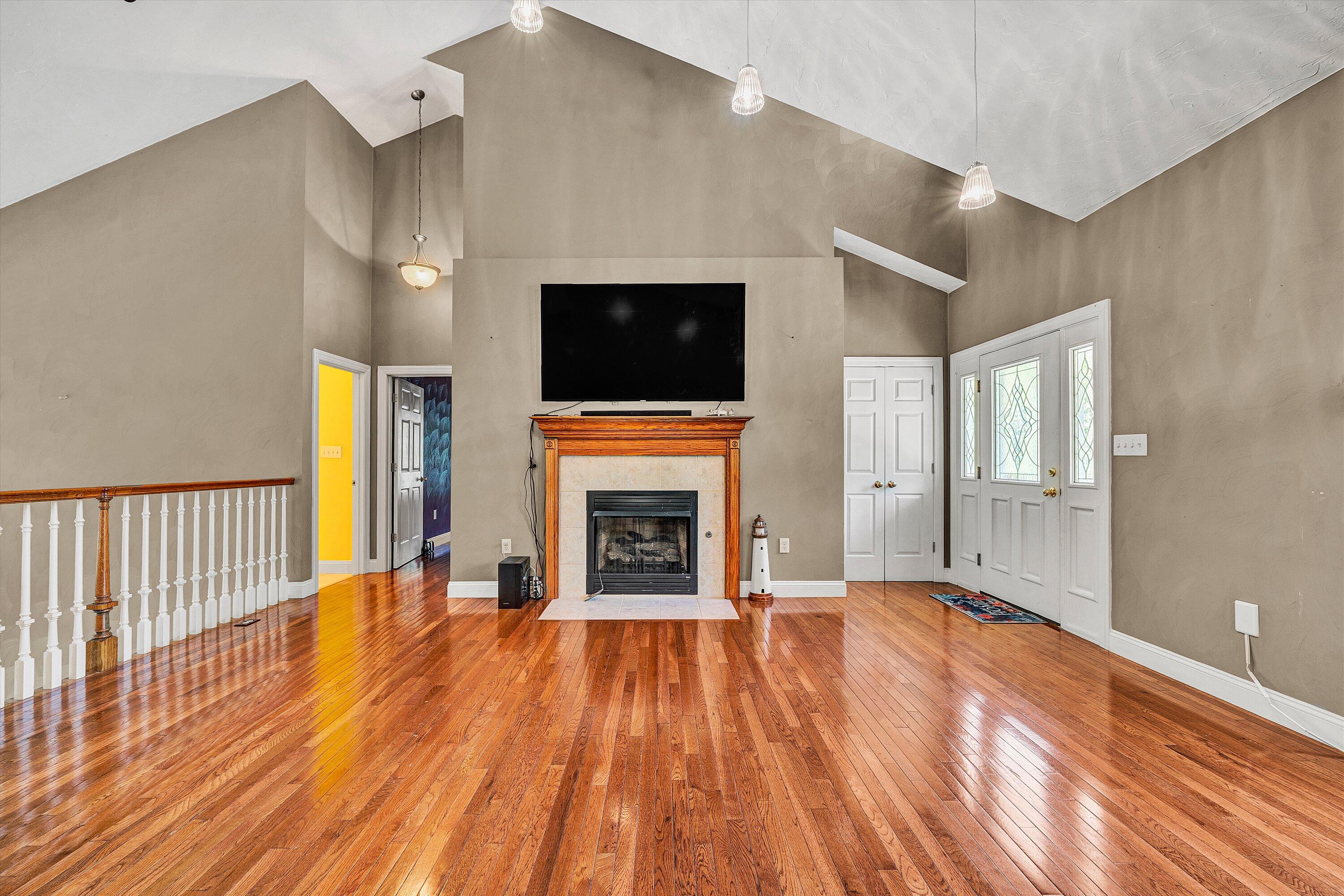 1805 Carroll Road Goodview, VA 24095 - Photo 7 of 61 a view of a livingroom with wooden floor and a fireplace