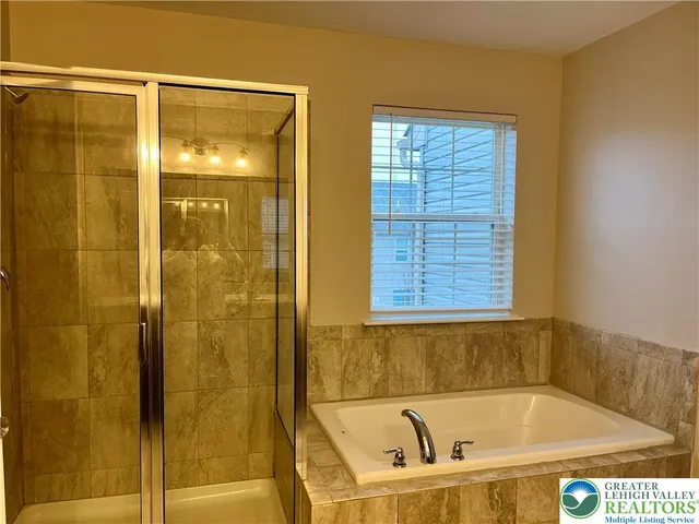 a bathroom with a tub and shower