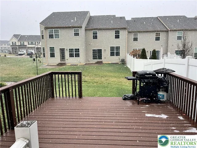 a front view of a house with yard and deck