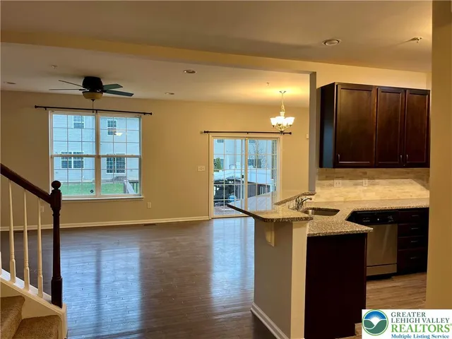 a view of a kitchen cabinets a sink and wooden floor