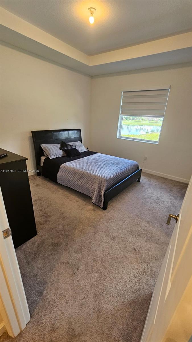 1146 Southeast 26th Street Homestead, FL 33035 - Photo 16 of 42 a bedroom with bed and window